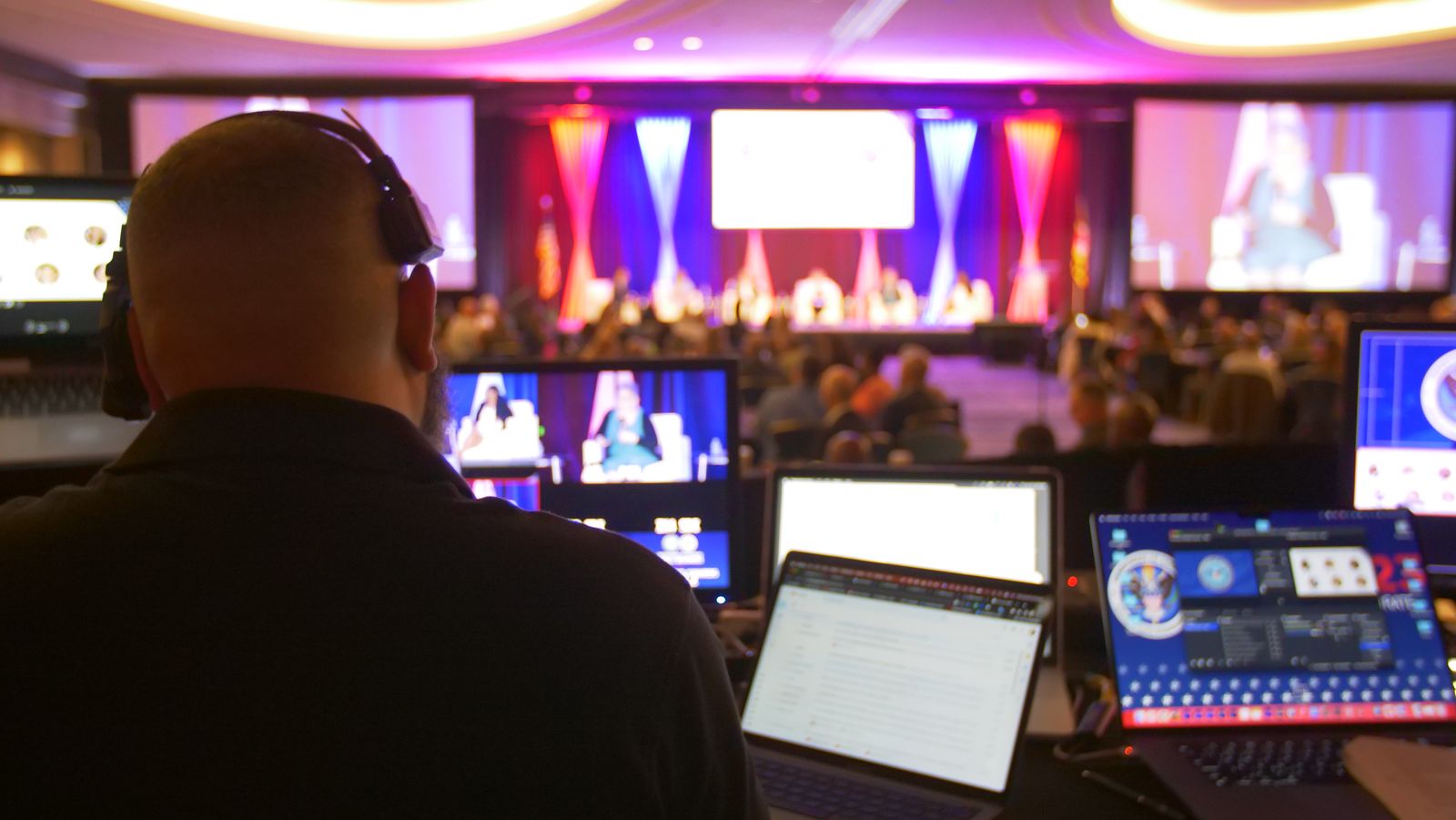 Production technician at a multi-screen control station